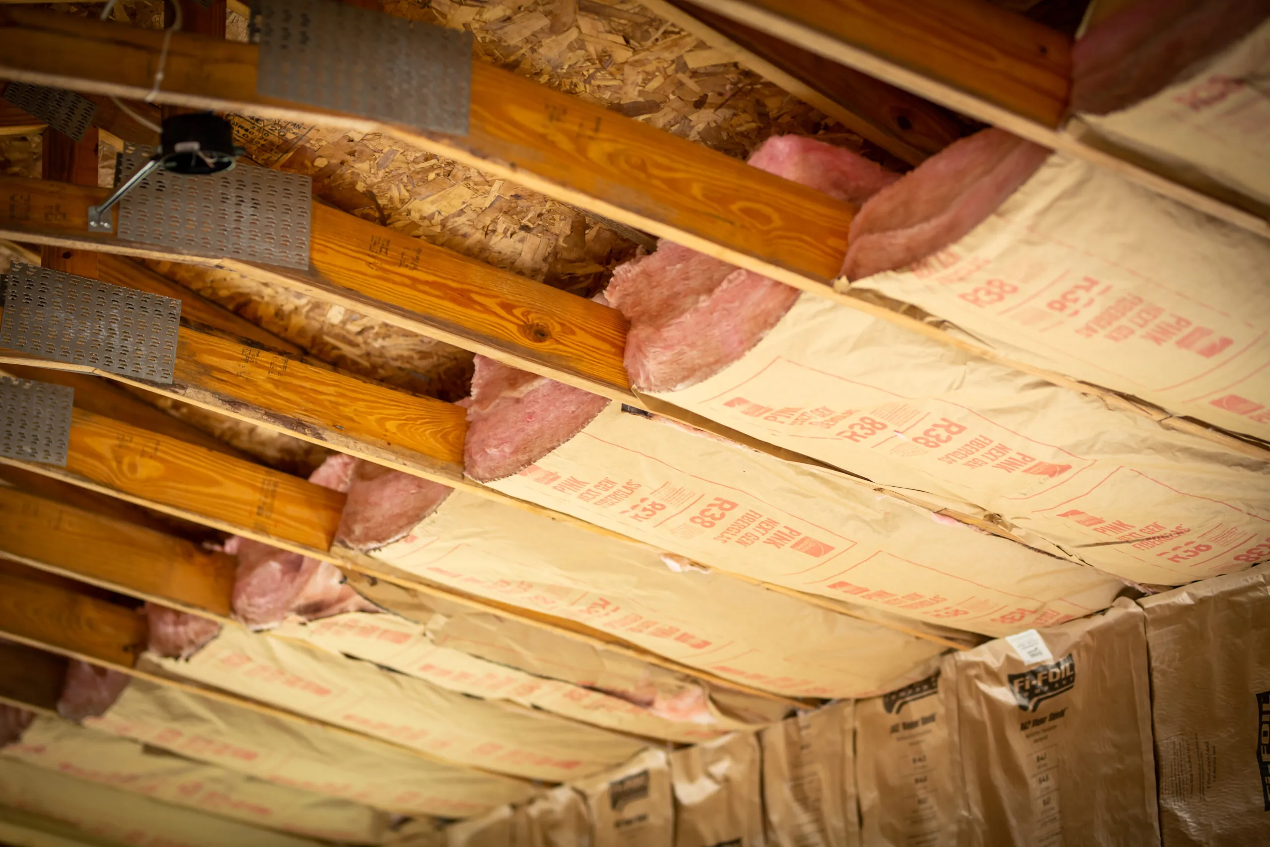Evenly installed batt insulation in a crawl space improving energy efficiency.