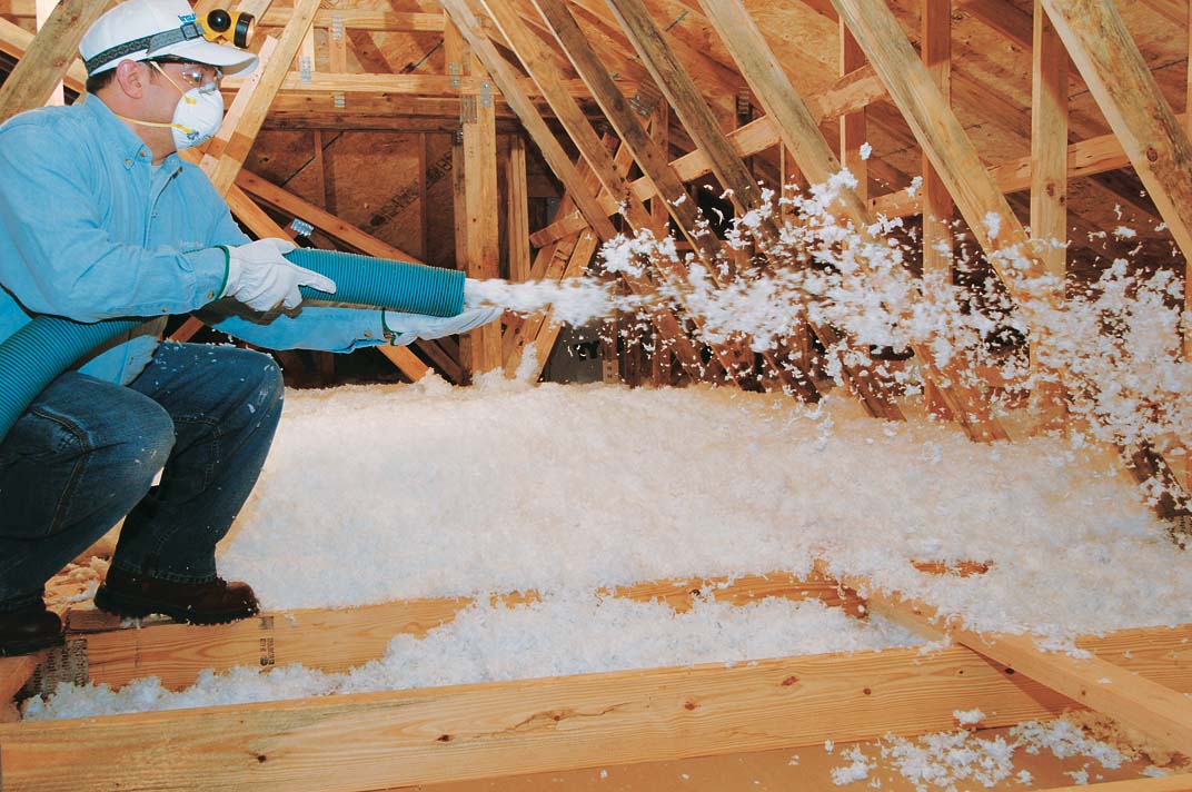Attic with batt insulation and blown-in insulation layered together.