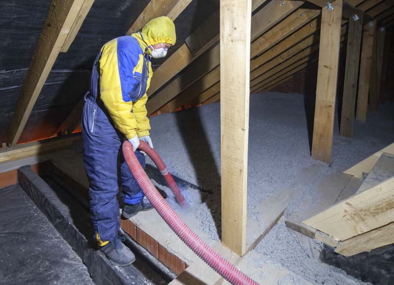 Blown-in insulation being installed in a residential attic.