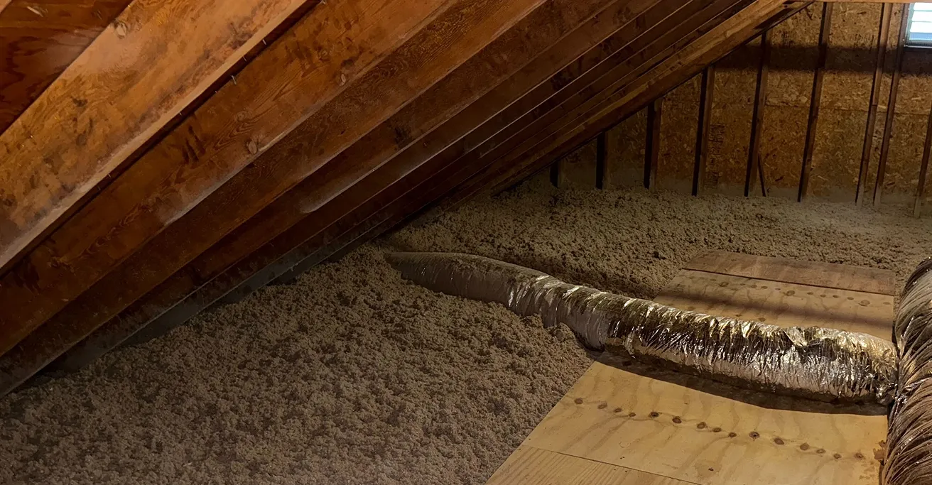 Attic floor covered with loose-fill insulation.