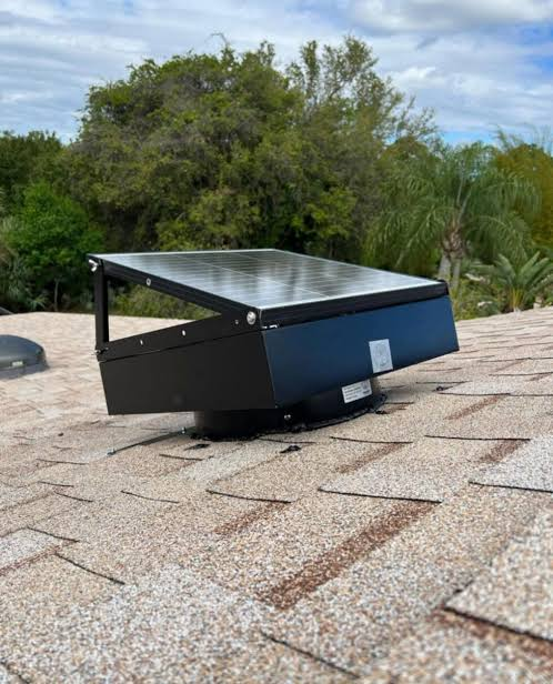 Solar attic fan exhausting hot air from a residential roof